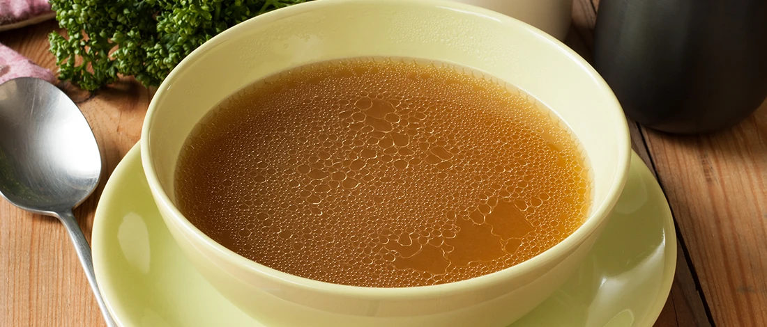 An image of beef broth on a bowl