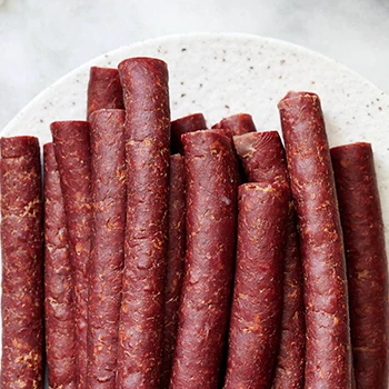 A top view image of beef sticks on a plate