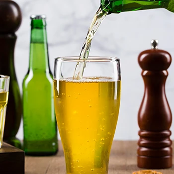 Pouring beer on a glass