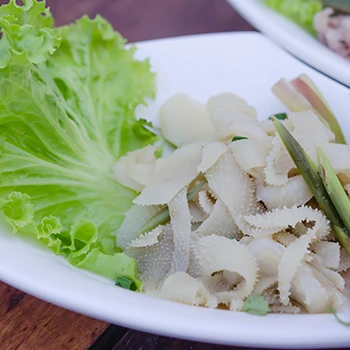 Cooked tripe meat on a plate with lettuce