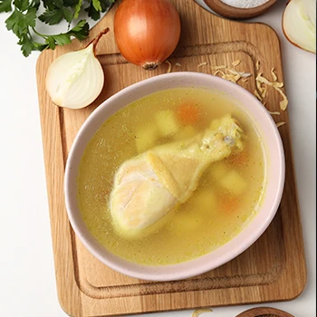 An image of chicken broth on a wooden board