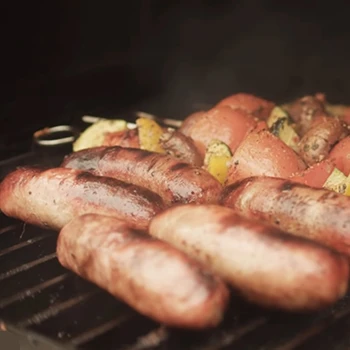 An image of grilled sausages inside a smoker