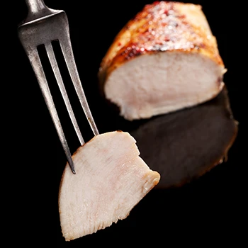 An image of chicken meat on a fork