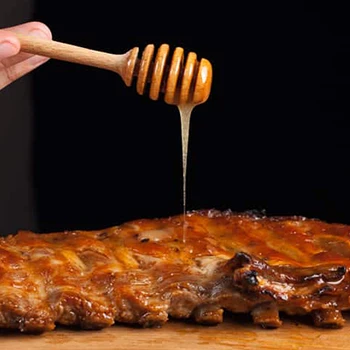 An image of a person pouring honey on top of a meat