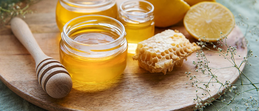 An image of honey on a wooden board