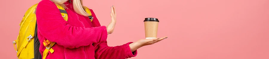 A picture of a woman rejecting a cup of coffee