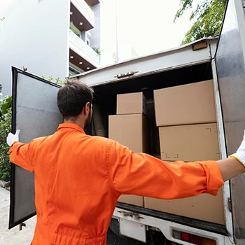 A delivery guy opening a truck full of boxes