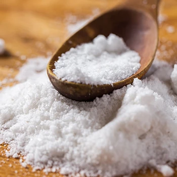 Close up image of salt with wooden spoon