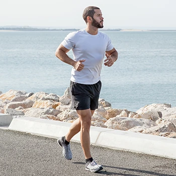 A man doing a jog at a seaside