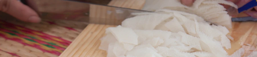 A woman chopping tripe meat