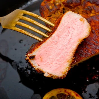 An image of pink pork in a fork