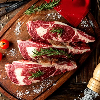 A top view image of raw beef meat on wooden board