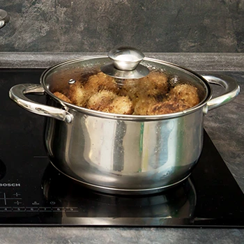 An image of braising meat in a pot