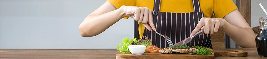 An image of a woman having a carnivore meal on a table