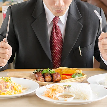 An image of a man who is about to eat different foods