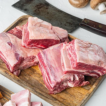 An image of sliced raw veal meat on a cutting board