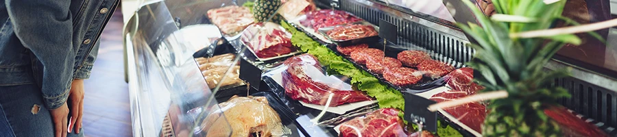 A woman shopping meat at a butcher shop