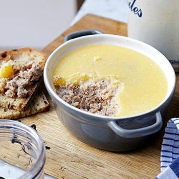 An image of potted meat on a wooden board