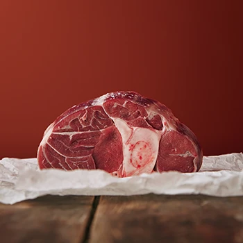 An image of raw meat resting on top of a paper packaging