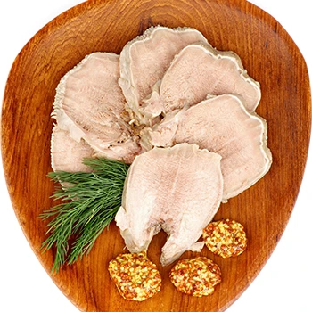 A top view image of raw beef tongue on a wooden plate