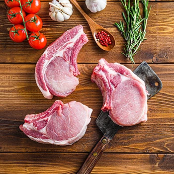 A top view image of raw pork chop cuts on a top of a table