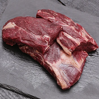 An image of natural and fresh meat on a black slate