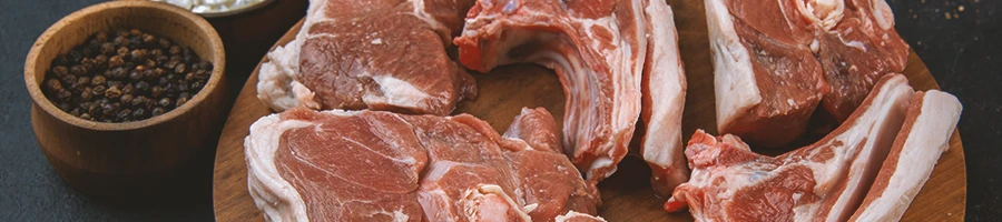 An image of different pork cuts on a wooden board