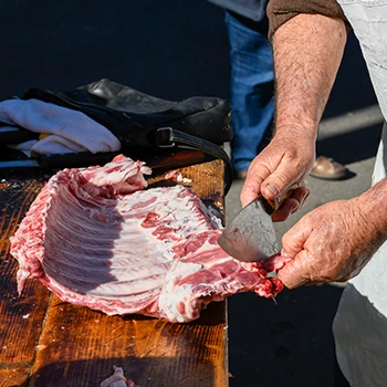 A butcher slicing a kosher meat