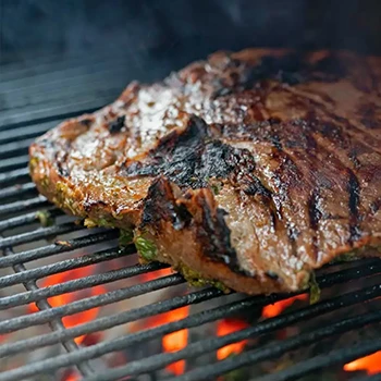 An image of carne asada on a grill