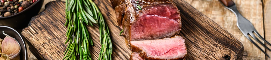 An image of sliced veal meat on a chopping board