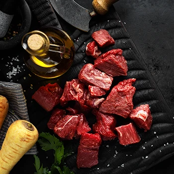An image of stew meat on a black slate