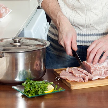 An image of a guy preparing for wet curing of meat