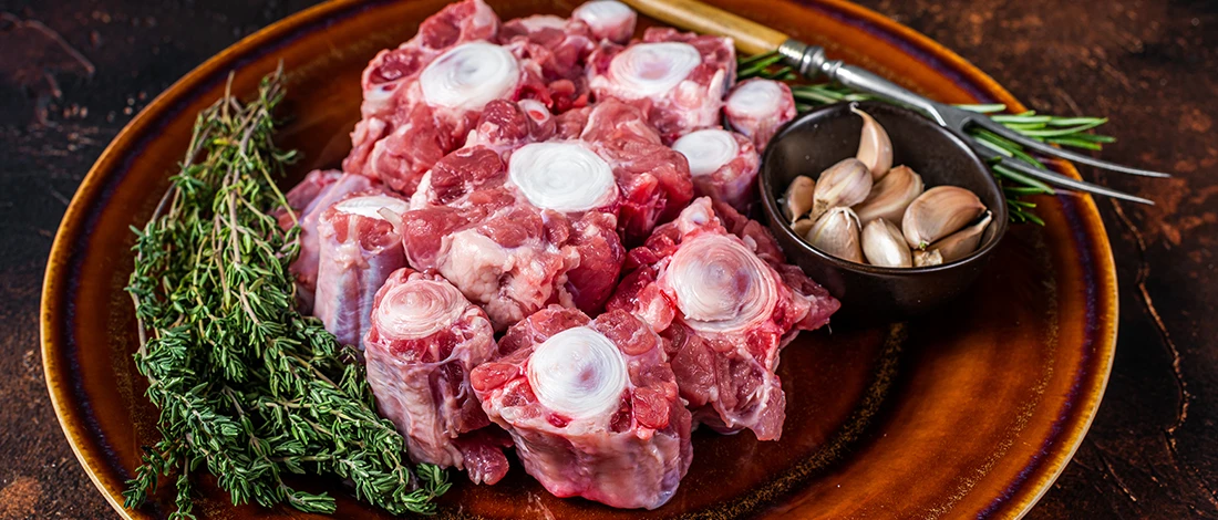 An image of sliced oxtail meat on a brown plate
