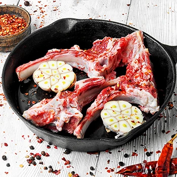 An image of a raw lamb or veal meat in a cooking pan