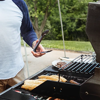 a picture of a man using the best grill for a beginner