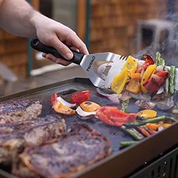 An image of a man cooking using a flat top grill with a good cooking area thickness