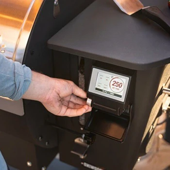 An image of a person adjusting the cooking temperature range of a pellet grill