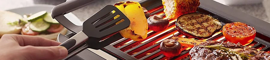 A close up image of a person using a best smokeless grill