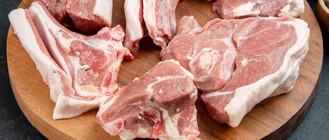 An image of pork meats on top of a wooden board