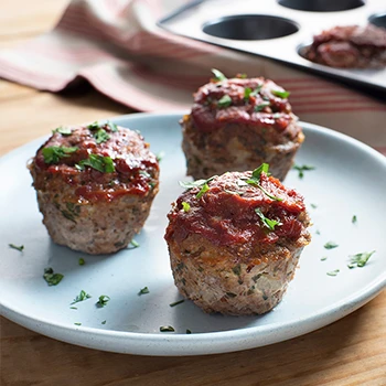 An image of three keto meatloaf cupcakes on a white plate