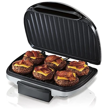 An image of an indoor grill with its lid open and food inside