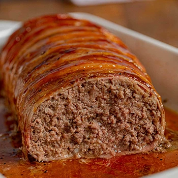 An image of a delicious meatloaf wrapped in bacon