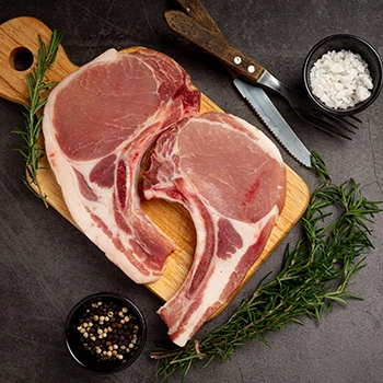 A top view image of pork meat on top of a wooden board