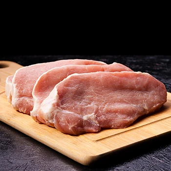 An image of pork meat slices with a dark background