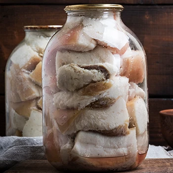 An image of meat preserved in a jar using lard