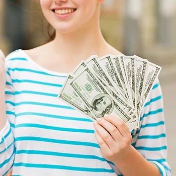 An image of a woman holding dollar bills