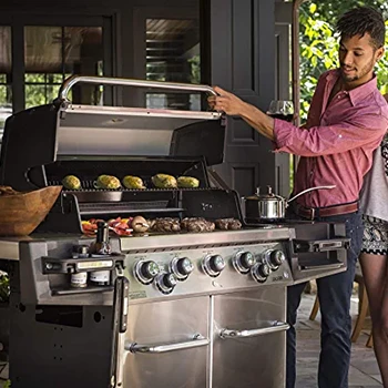 An image of a guy checking the size of a rotisserie grill