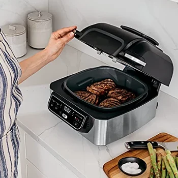 An image of a woman using a smokeless grill indoor