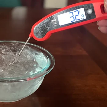 Testing out a meat thermometer in a bowl filled with ice and water