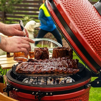 An image of a person cooking using a kamado grill